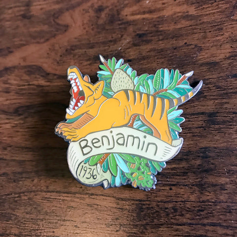 A soft enamel pin with epoxy featuring Benjamin, the last Tasmanian Tiger. By Kory Bing.