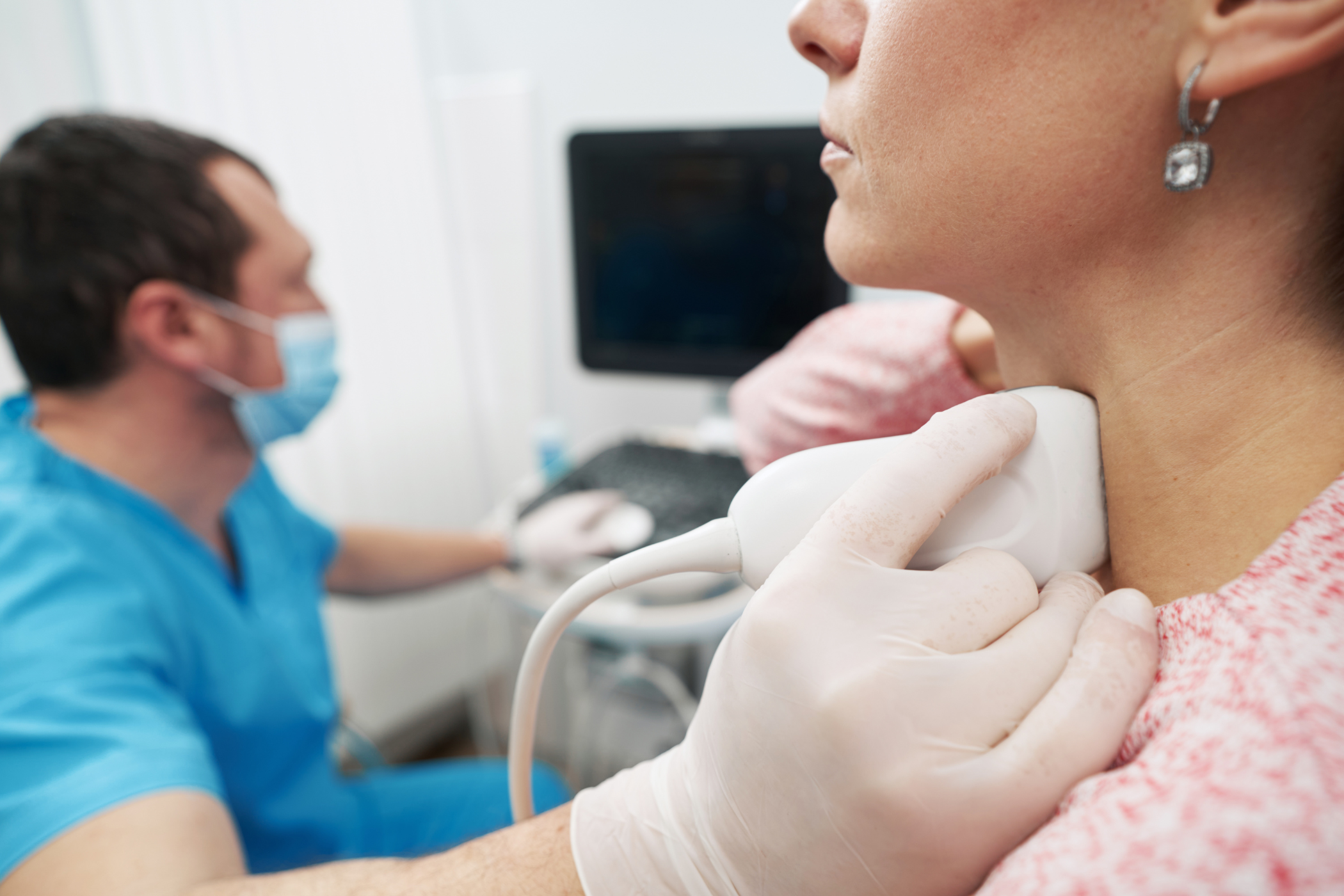 Woman having a thyroid exam