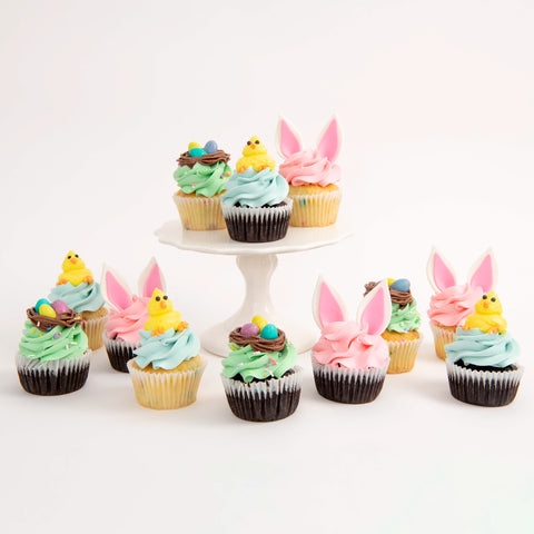 easter cupcakes, some of them have ear bunny ears and others cute little yellow easter chicks