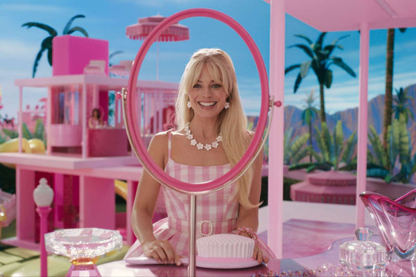 Margot Robbie dressed in a pink gingham dress for the new live-action Barbie movie by Greta Gerwig. Image: Warner Bros.