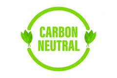 Green 'carbon neutral' signage on white background, featuring two green leaves either side.