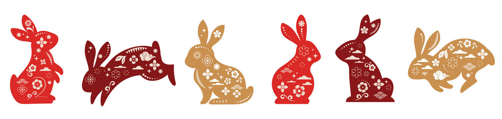 Six jewel-toned rabbits representing The Year of the Rabbit 2023, lined up in various positions of standing, sitting and hopping.