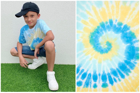 Too cool for school. (L-R) The young boy wears a Blue and Yellow Boys Tie-Dye T-shirt by Gen Woo. A close-up of the bold colours and classic pinwheel pattern.Too cool for school. (L-R) The young boy wears a Blue and Yellow Boys Tie-Dye T-shirt by Gen Woo. A close-up of the bold colours and classic pinwheel pattern.