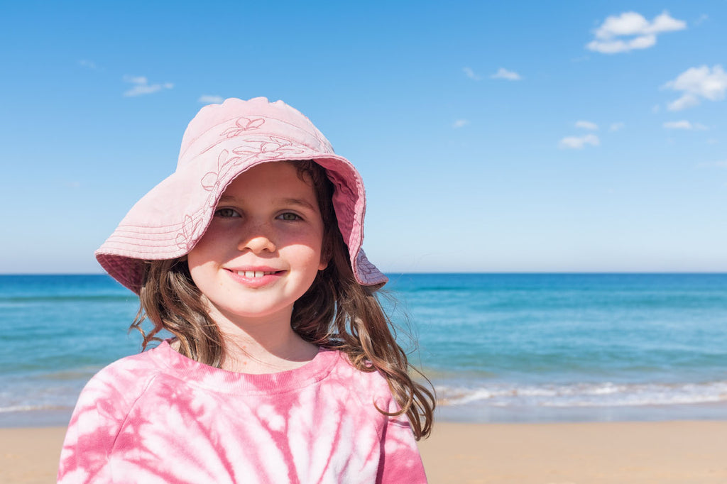 Girl in bucket hat on the beach