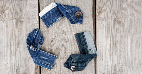 Denim fabric cut and positioned in the shape of the universal recycling symbol. (GreenMatters / ISTOCK)