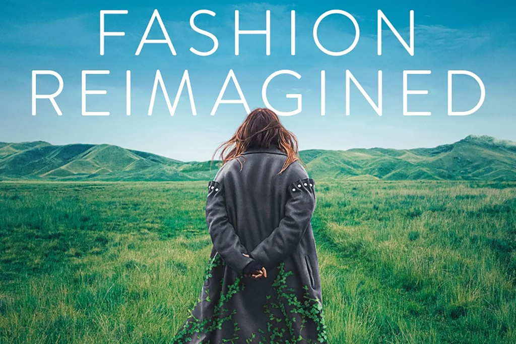 Back shot of Amy Powney silhouetted against fields of green and rolling hills, ‘Fashion Reimagined’ text across the top.