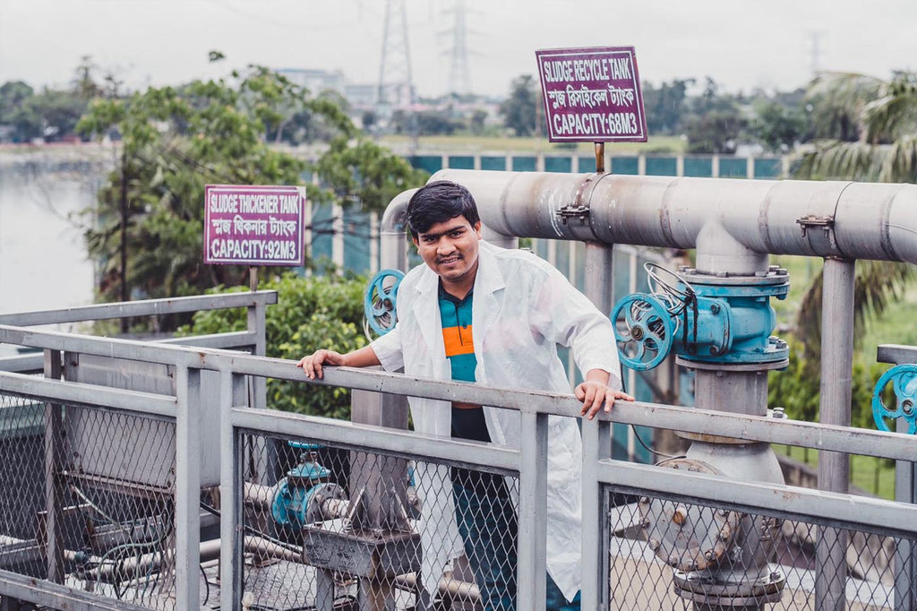 Man standing on balcony at sludge recycle centre in Bangladesh factory