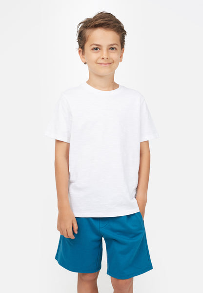 Young boy wears white t-shirt and blue shorts by Gen Woo