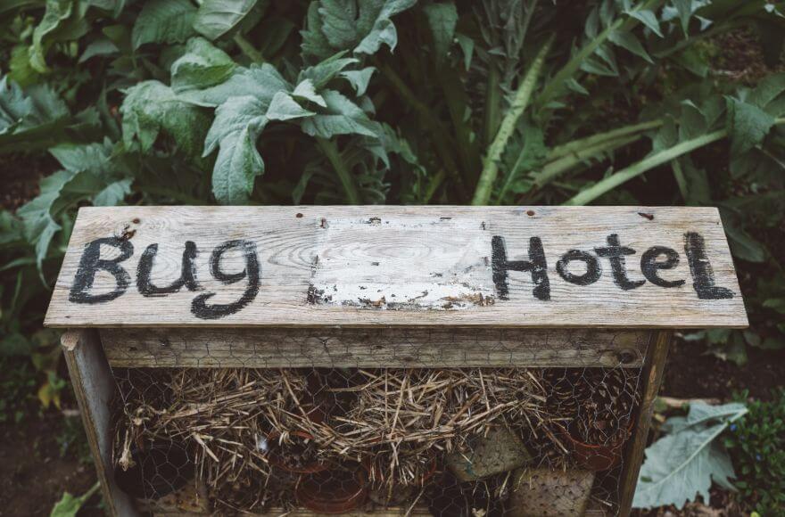 Shabby bug hotel with pots and straw