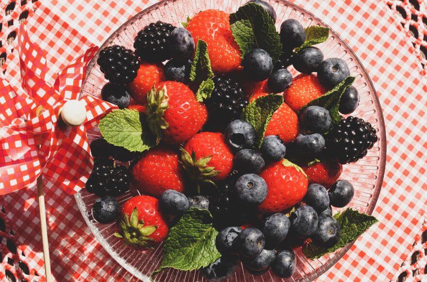 Strawberries and blueberries in a glass bowl