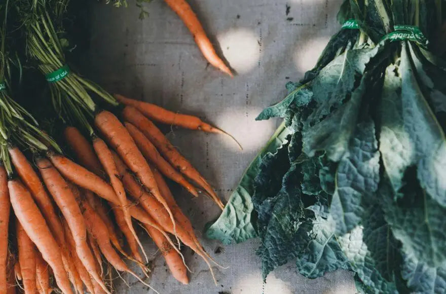 Carrot and leafy vegetables at a market.