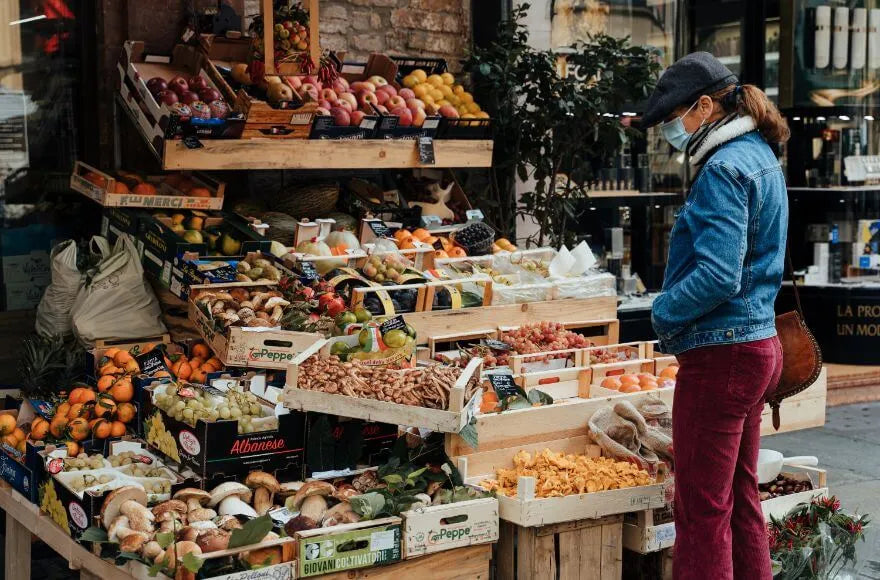 A woman shops at an organic food market stall.