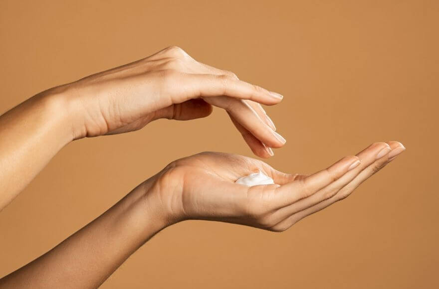 Woman's hand applying cream