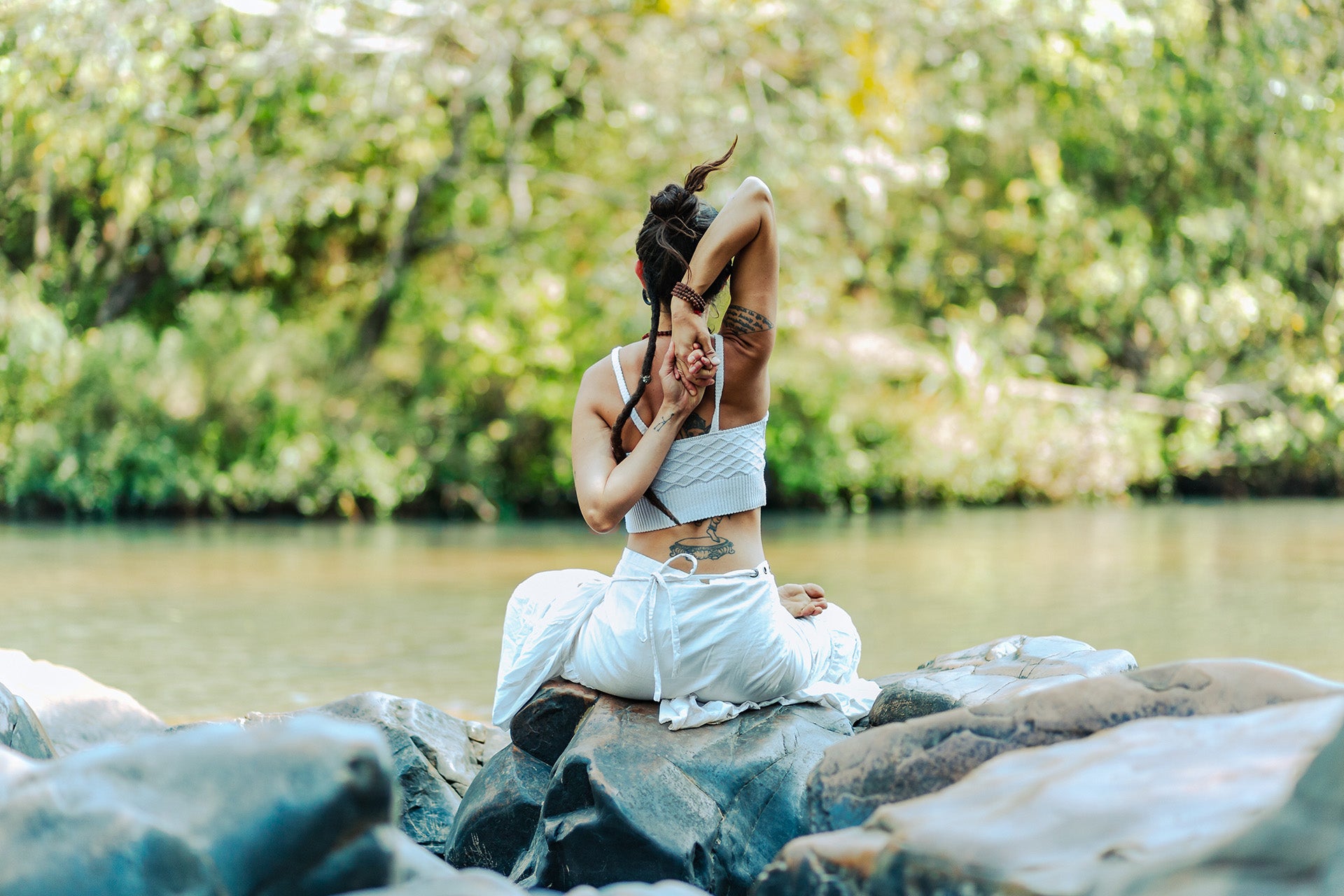 woman meditating at lake