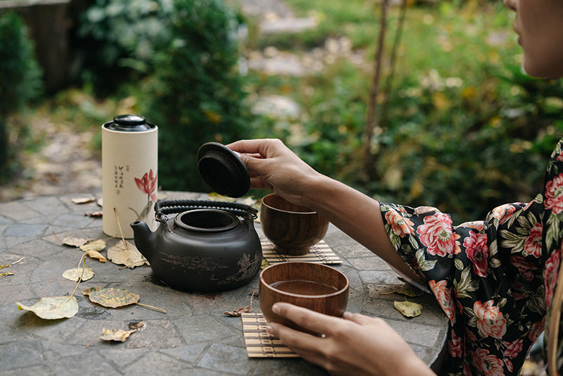 person pouring tea for mindfulness
