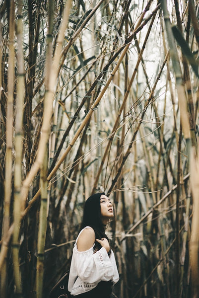 woman standing in bamboo garden