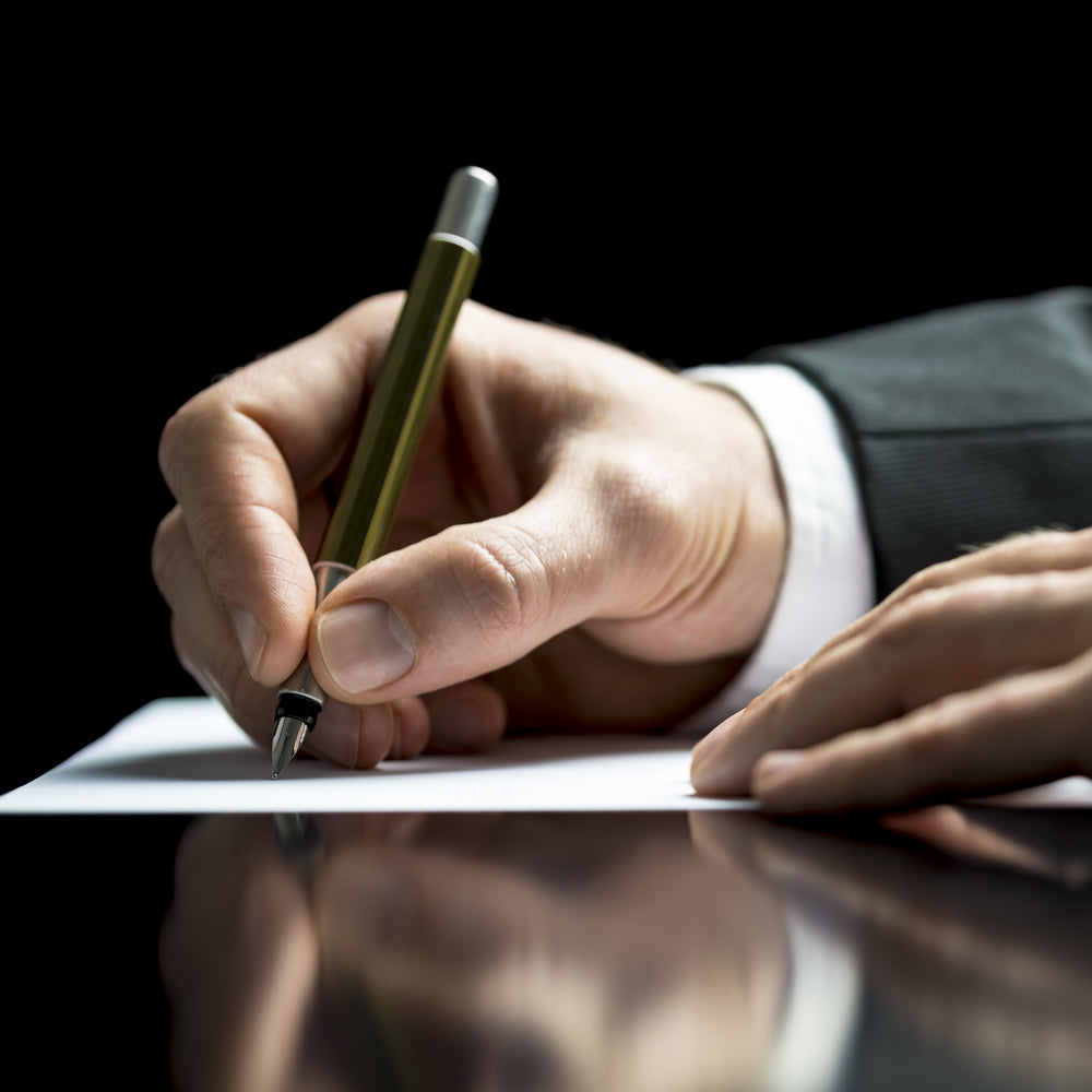 Businessman writing on a sheet of white