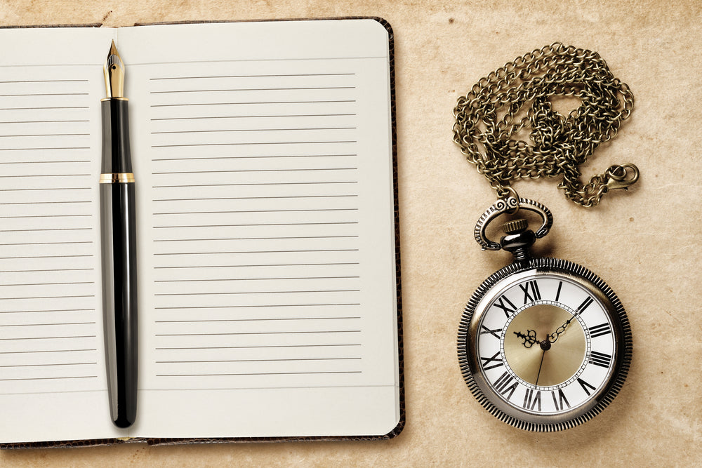 Diary with fountain pen and vintage pocket watch