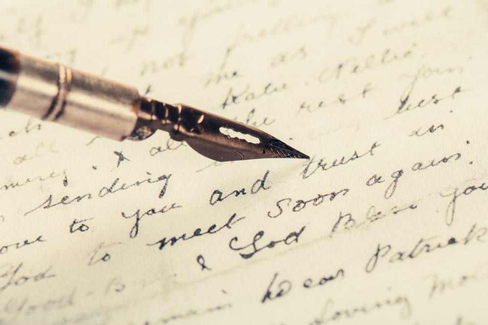 Fountain pen on an ancient handwritten letter.