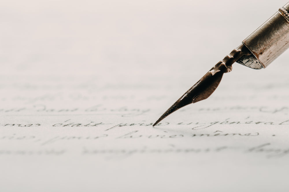 Fountain pen on an ancient handwritten letter