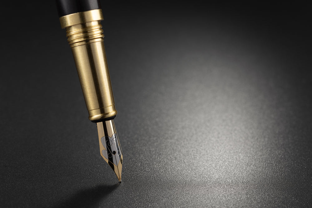 Fountain pen on top of a dark background