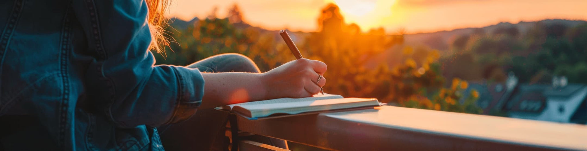 On a balcony at sunset, writing down their achievements