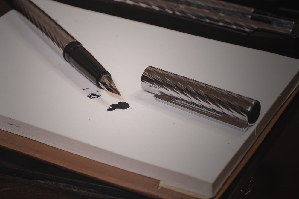 fountain pen with its lid off making splotches