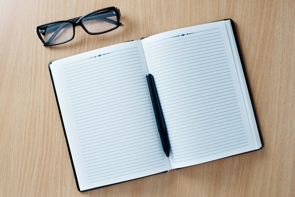 journal and sunglasses