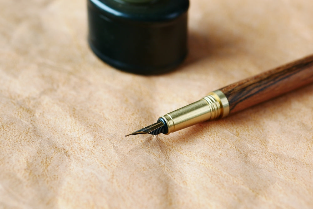 old empty paper and fountain pen on table