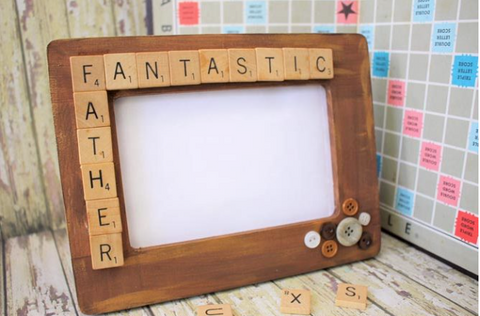 Brown picture frame with scrabble letters glued to it that say "fantastic father"