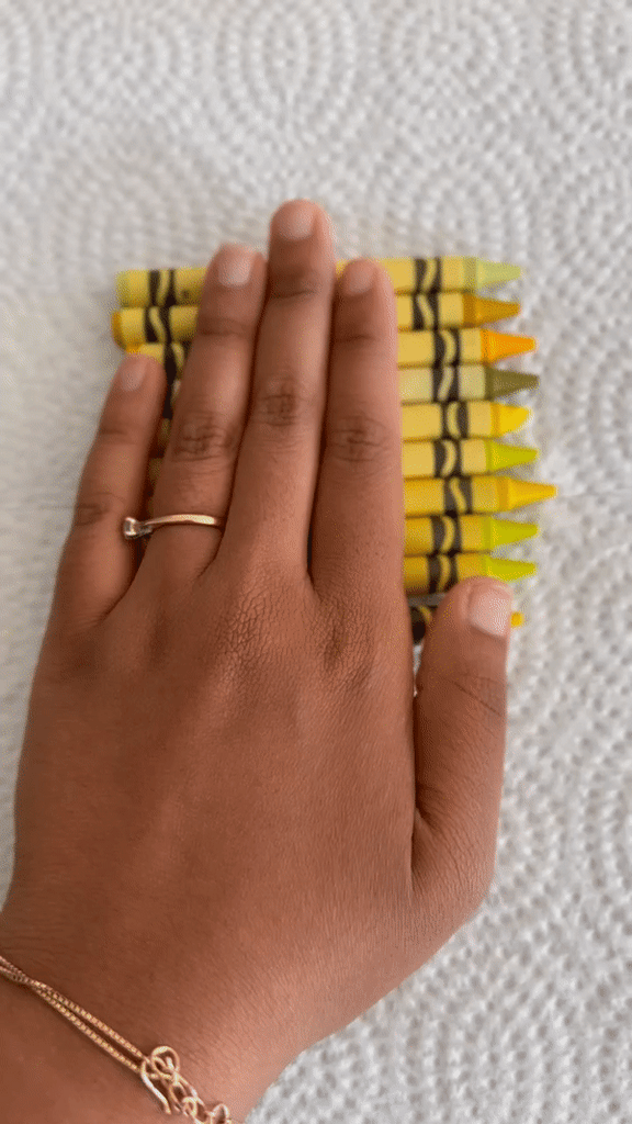 GIF of someone removing labels from yellow crayons