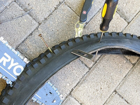 Bike tire with chainsaw and tools shoved through it