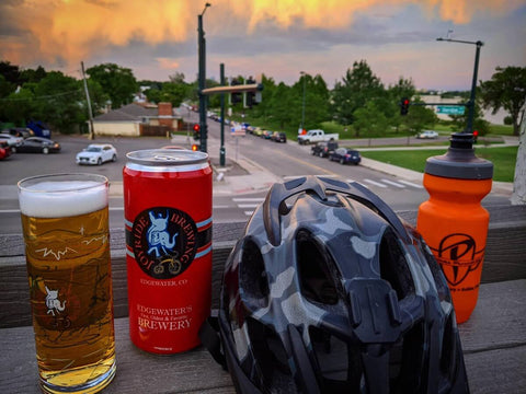 Rooftop of Joyride Brewing showing a bike helmet, water bottle, and beer.