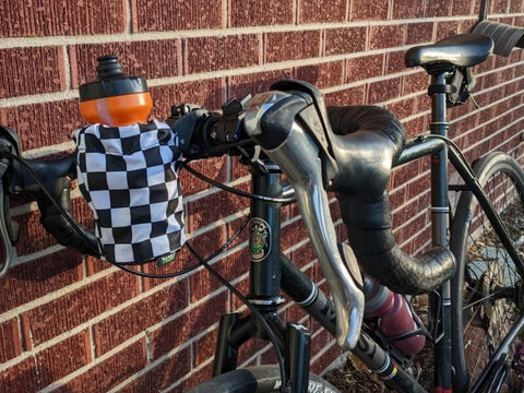 Gravel bike with handlebar mounted water bottle holder