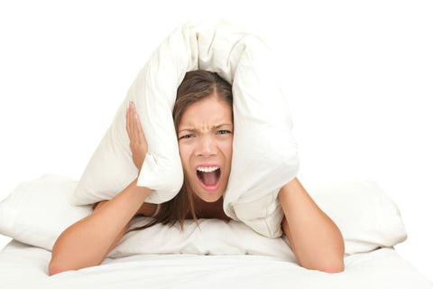 Which environmental factors affect Good Sleep, woman with pillow on her head covering ears from noise