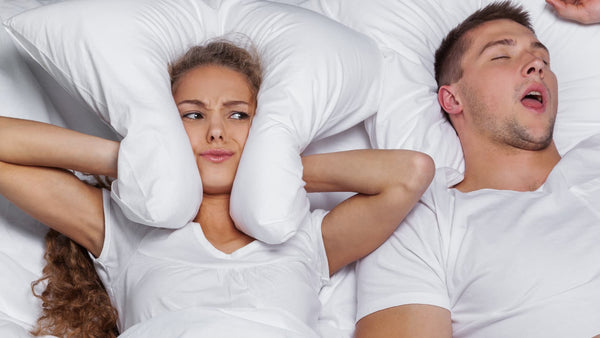 how to make someone stop snoring, sleeping with a snorer, stop someone from snoring while they sleep, woman and man in bed snoring