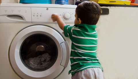 How to wash a bamboo pillow, boy playing with controls of washing machine