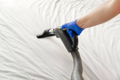 Vacuuming mattress topper, mattress being vacuumed