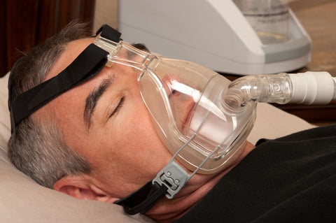 CPAP machines can make you feel uncomfortable while sleeping, man sleeping with CPAP mask on