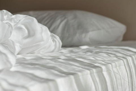 What makes a hybrid mattress, white mattress in the morning with light ray on it