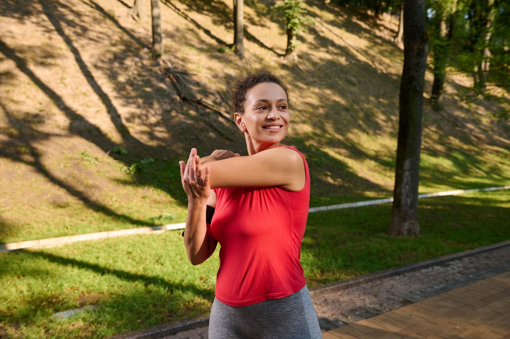 Woman exercising outdoors, exercising regularly promotes deep sleep