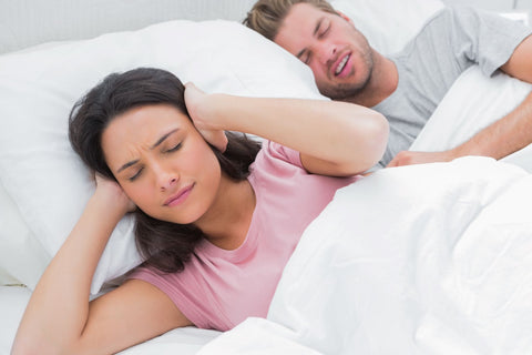 How to block out snoring sounds, woman in bed due to snoring partner