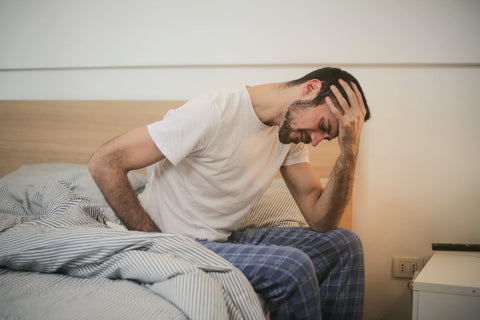 low oxygen level leads to headache after sleep, man on bed having a headache