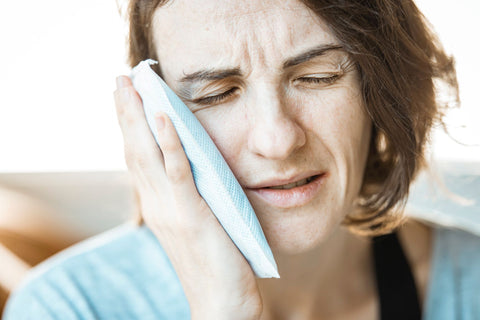 Cold Compress for toothache before bed, woman using cold compress for toothache