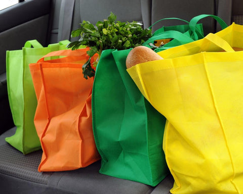 colorful reusable shopping bags full of groceries