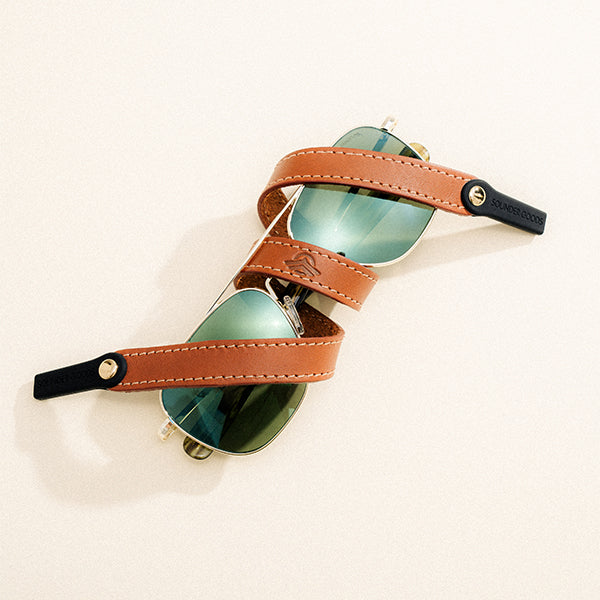 RANDOLPH for The Sounders Goods Aviators wrapped in the Randolph for The Sounder Goods Leather Sunglass Strap