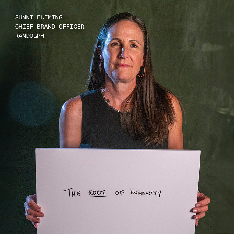 Randolph Chief Brand Officer Director Sunni Fleming holding a sign, explaining what femininity means to her.