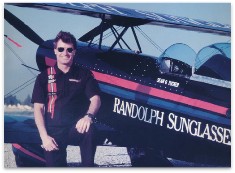 Sean Tucker poses in front of a jet sponsored by Randolph Sunglasses. 