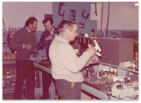 Jan Waszkiewicz, one of Randolph Engineering's founders, examining frames in the machine shop. 