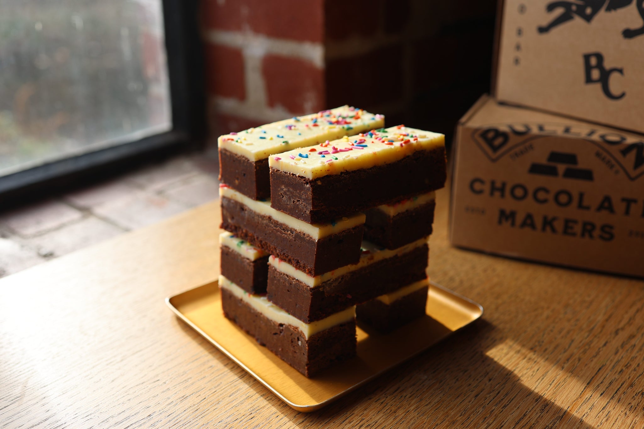 Stack of brownies with white chocolate ganache and sprinkles